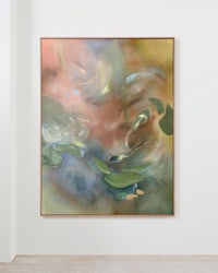 an abstract painting hanging on a wall